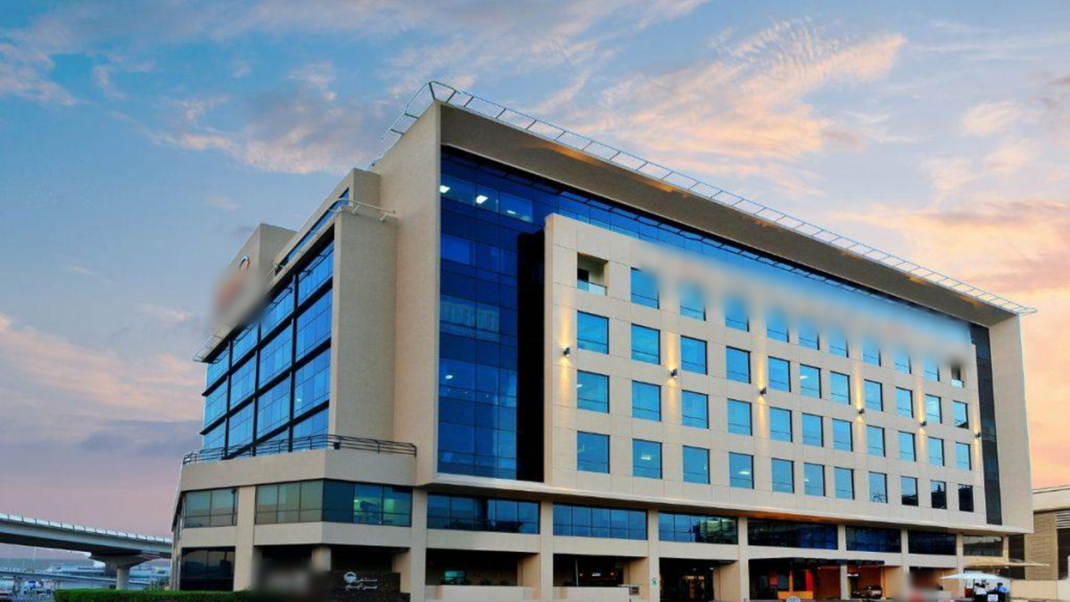 Modern multi-department hospital building at dusk