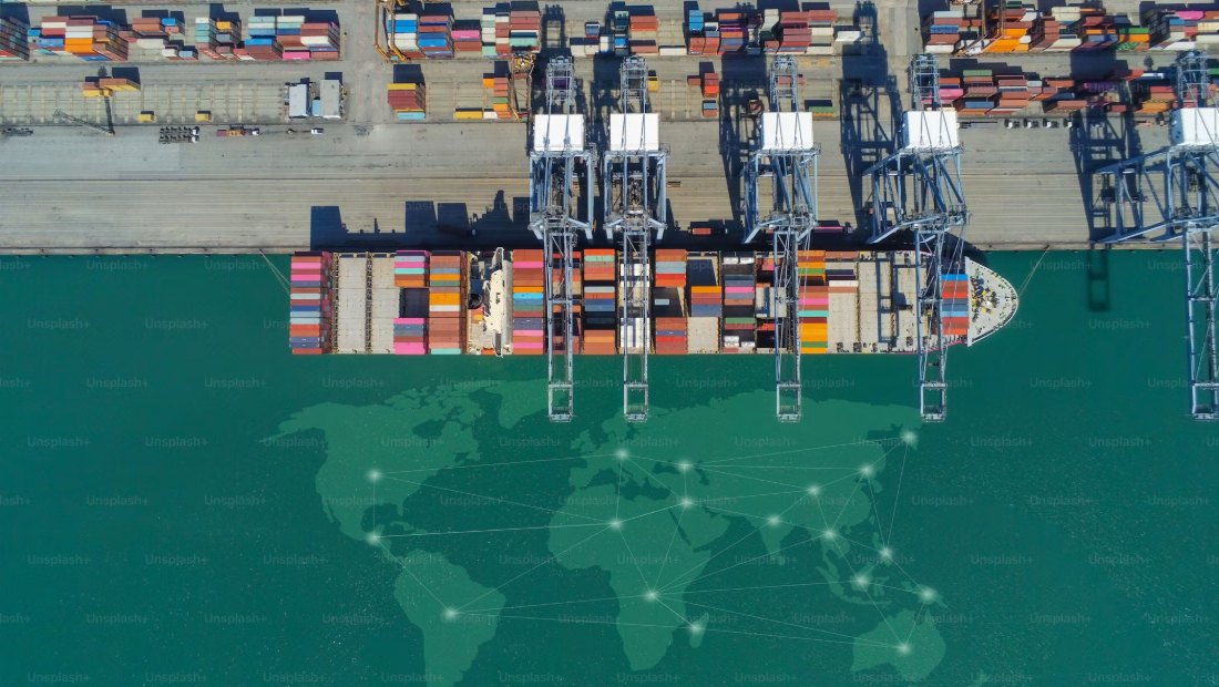 Quay cranes working a container vessel at a terminal