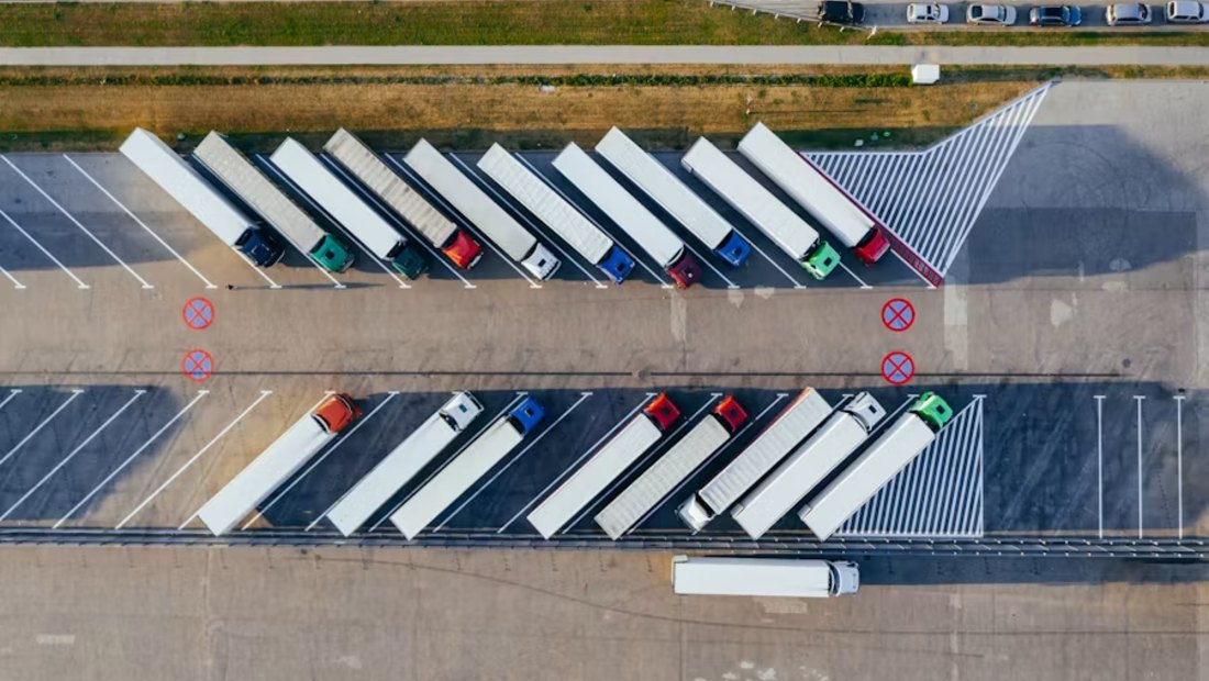 Trailers parked in rows at a logistics yard, seen from above